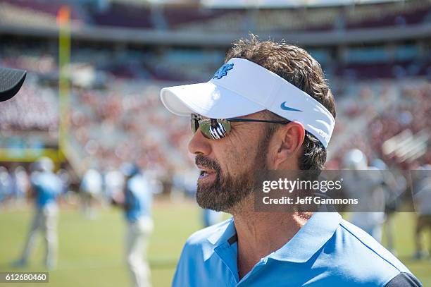 Head Coach of the North Carolina Tar Heels Larry Fedora talks to an official before the game with the Florida State Seminoles at Doak Campbell...