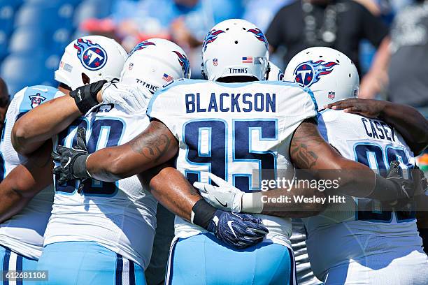 Angelo Blackson of the Tennessee Titans huddles with his defensive teammates before a game against the Oakland Raiders at Nissan Stadium on September...