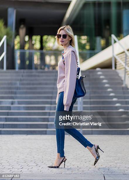 German fashion blogger Lisa Hahnbueck wearing pink Off-White Backless Sweatshirt, JBrand Highwaist Jeans, blue FENDI Pekaboo Bag, Guess Leopard Print...