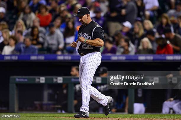 Walt Weiss of the Colorado Rockies walks to the mound to make a pitching change during a game against the Milwaukee Brewers at Coors Field on...
