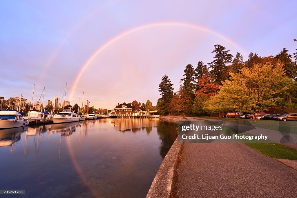 Stunning morning rainbow over yacht club in Stanley Park, Vancouver
