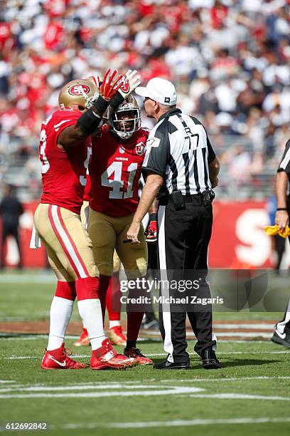 NaVorro Bowman and Antoine Bethea of the San Francisco 49ers argue a non-call with official Terry McAulay during the game against the Dallas Cowboys...