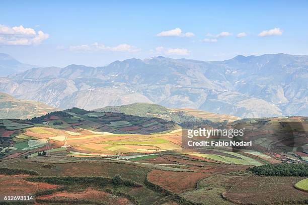 sunrise over dongchuan red land, one of the landmarks in yunnan province, china - dongchuan stock pictures, royalty-free photos & images