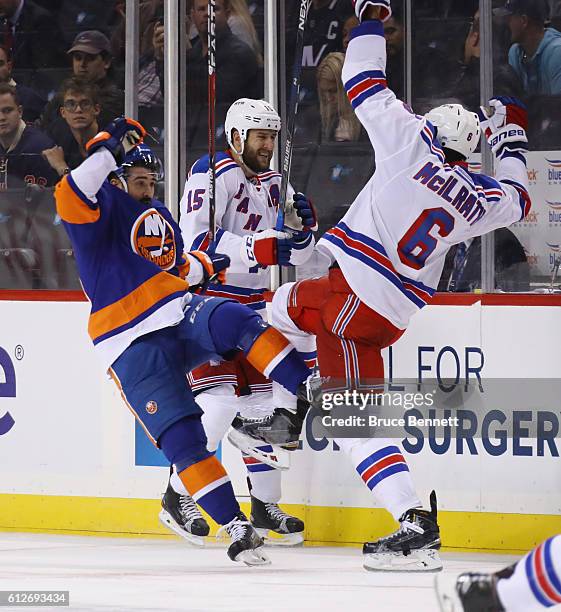 Cal Clutterbuck of the New York Islanders bounces off Dylan McIlrath of the New York Rangers during the second period at the Barclays Center on...