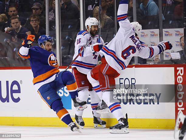 Cal Clutterbuck of the New York Islanders bounces off Dylan McIlrath of the New York Rangers during the second period at the Barclays Center on...