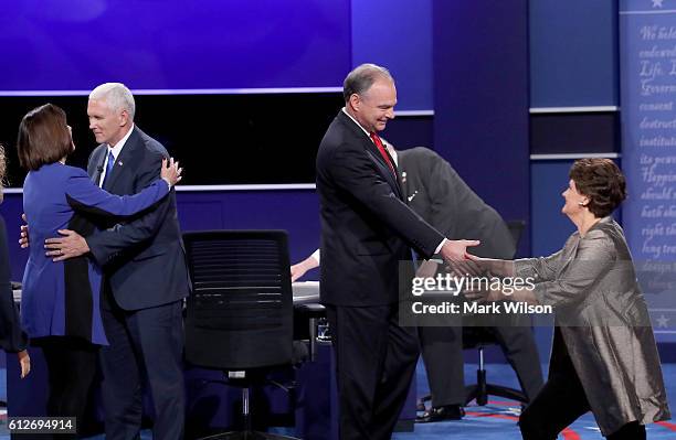 Republican vice presidential nominee Mike Pence and Democratic vice presidential nominee Tim Kaine are greeted by their spouses Karen Pence and Anne...