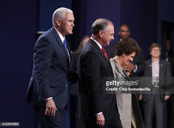 Republican vice presidential nominee Mike Pence, Democratic vice presidential nominee Tim Kaine and his wife Anne Holton stand on stage following the...