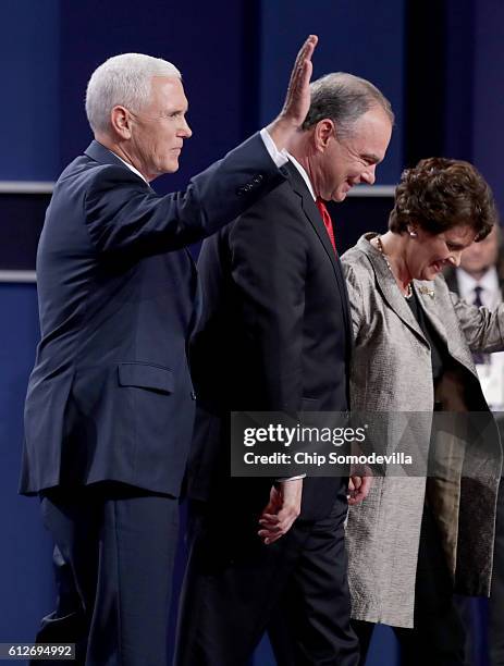 Republican vice presidential nominee Mike Pence, Democratic vice presidential nominee Tim Kaine and his wife Anne Holton stand on stage following the...