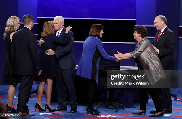 Karen Pence and Anne Holton shake hands after their husbands Republican vice presidential nominee Mike Pence and Democratic vice presidential nominee...