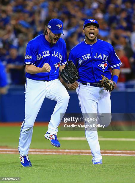 Jason Grilli of the Toronto Blue Jays and Edwin Encarnacion react after the third out in the eighth inning against the Baltimore Orioles during the...