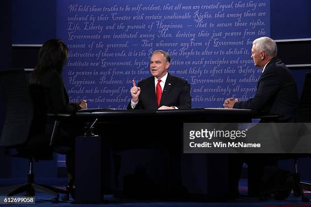 Democratic vice presidential nominee Tim Kaine and Republican vice presidential nominee Mike Pence debate as debate moderator Elaine Quijano listens...