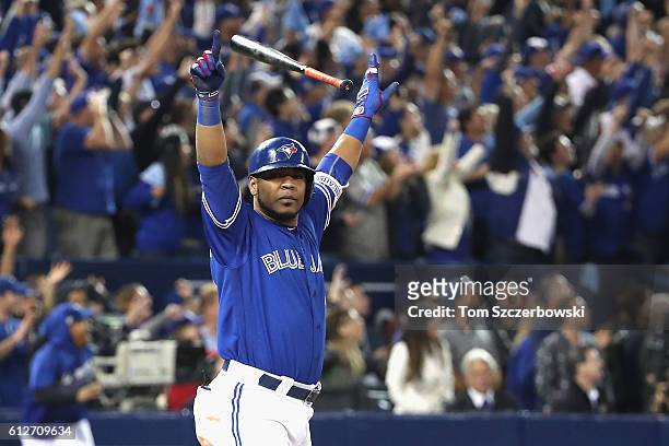 Edwin Encarnacion of the Toronto Blue Jays reacts after hitting a three-run walk-off home run in the eleventh inning to defeat the Baltimore Orioles...