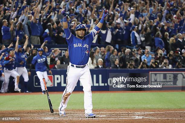 Edwin Encarnacion of the Toronto Blue Jays reacts after hitting a three-run walk-off home run in the eleventh inning to defeat the Baltimore Orioles...