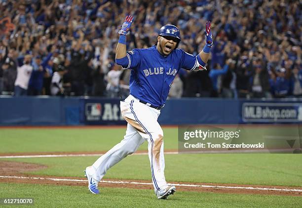 Edwin Encarnacion of the Toronto Blue Jays reacts after hitting a three-run walk-off home run in the eleventh inning to defeat the Baltimore Orioles...