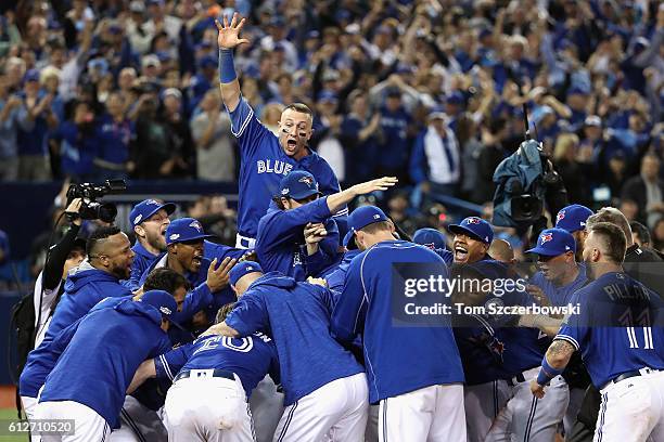 Troy Tulowitzki and the Toronto Blue Jays celebrate defeating the Baltimore Orioles 5-2 to win the American League Wild Card game at Rogers Centre on...