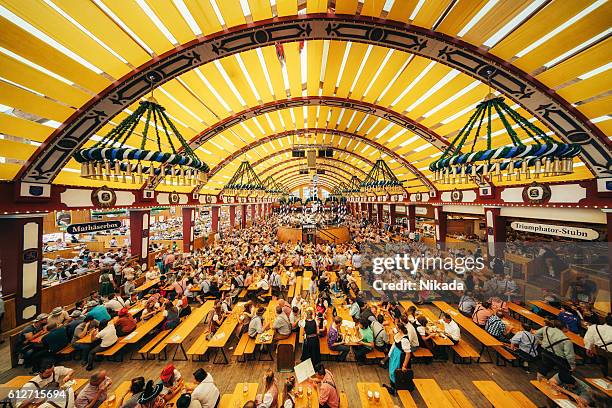 oktoberfest in munich, loewenbraeu brewery's festive tent - biergarten münchen stock pictures, royalty-free photos & images