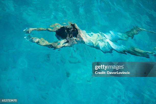 the metamorphosis of the being into naked man in water - photo realism stock pictures, royalty-free photos & images