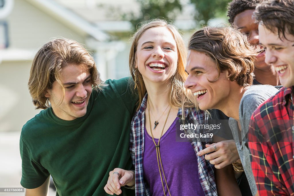 Group of five multi-ethnic teenagers hanging out