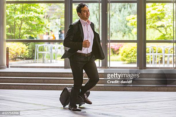 rushing business person running with a suitcase - japanese foreign office stock pictures, royalty-free photos & images