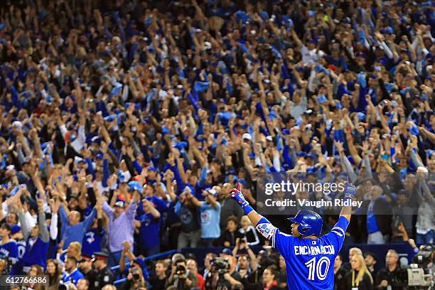 Edwin Encarnacion of the Toronto Blue Jays reacts after hitting a three-run walk-off home run in the eleventh inning to defeat the Baltimore Orioles...