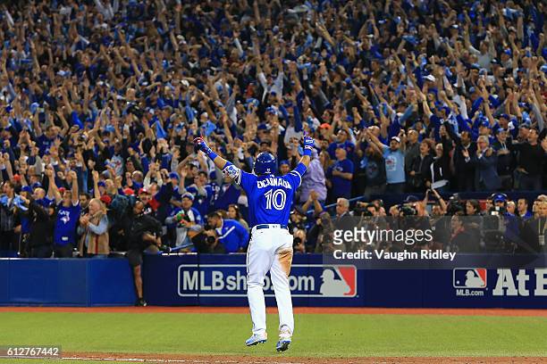 Edwin Encarnacion of the Toronto Blue Jays reacts after hitting a three-run walk-off home run in the eleventh inning to defeat the Baltimore Orioles...