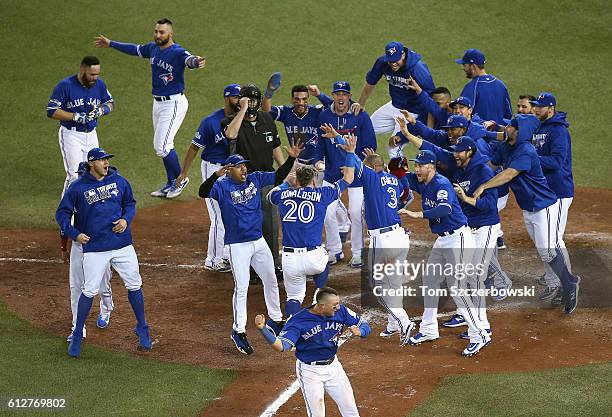 The Toronto Blue Jays celebrate defeating the Baltimore Orioles 5-2 in the eleventh inning to win the American League Wild Card game at Rogers Centre...