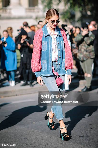Chiara Ferragni is wearing blue denim jeans, a pink and blue denim jacket, and a pink Chanel bag, outside the Chanel show, during Paris Fashion Week...
