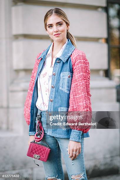 Chiara Ferragni is wearing blue denim jeans, a pink and blue denim jacket, and a pink Chanel bag, outside the Chanel show, during Paris Fashion Week...