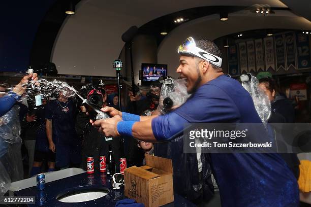 Edwin Encarnacion of the Toronto Blue Jays celebrates in the clubhouse after hitting a three-run walk-off home run in the eleventh inning to defeat...