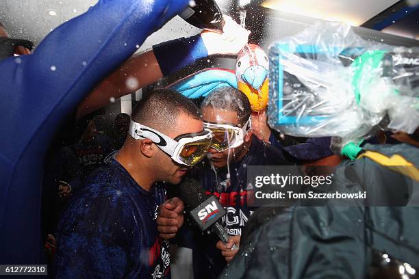 Edwin Encarnacion of the Toronto Blue Jays is doused with champagne in the clubhouse after hitting a three-run walk-off home run in the eleventh...