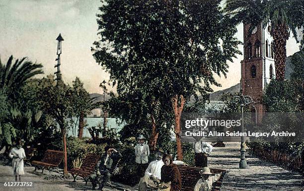 Color postcard of park with visitors in Guatmas, Cuba, circa 1915.