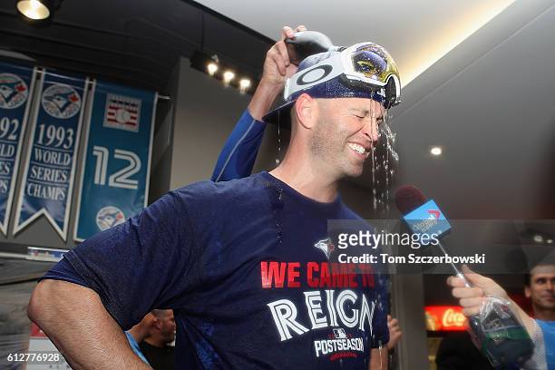 Happ of the Toronto Blue Jays celebrates in the clubhouse after defeating the Baltimore Orioles 5-2 in the eleventh inning to win the American League...