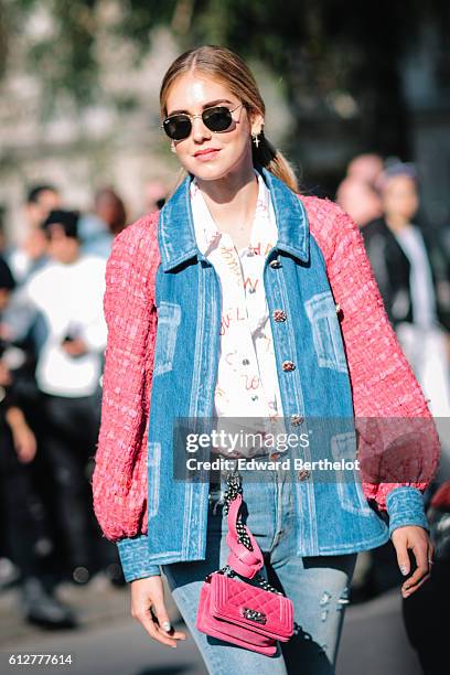 Chiara Ferragni is wearing blue denim jeans, a pink and blue denim jacket, and a pink Chanel bag, outside the Chanel show, during Paris Fashion Week...