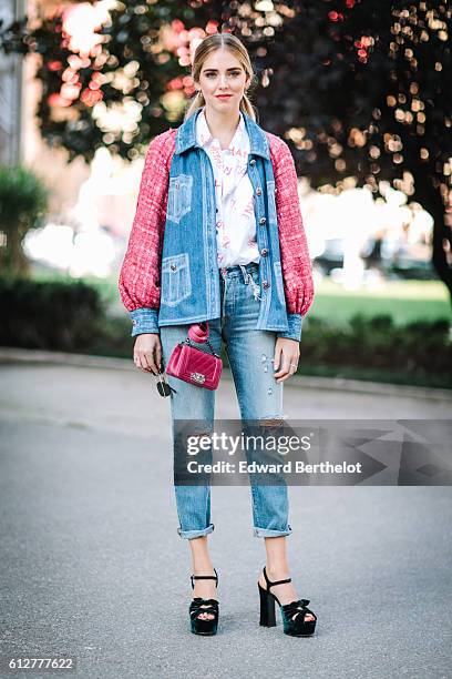 Chiara Ferragni is wearing blue denim jeans, a pink and blue denim jacket, and a pink Chanel bag, outside the Chanel show, during Paris Fashion Week...