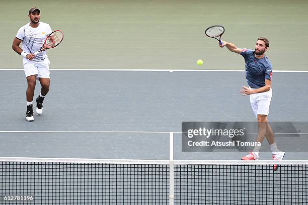 Gilles Simon of France and Aisam-Ul-Haq Qureshi of Pakistan in action during the men's doubles first round match against Oliver Marach of Austria and...
