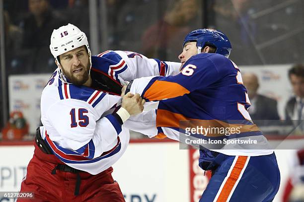 New York Rangers Left Winger Tanner Glass and New York Islanders Left Winger Eric Boulton square off during the first period of a preseason NHL game...