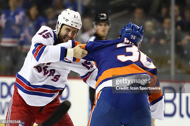 New York Rangers Left Winger Tanner Glass and New York Islanders Left Winger Eric Boulton square off during the first period of a preseason NHL game...