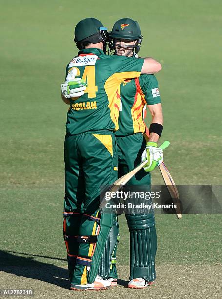 Tim Paine of Tasmania celebrates scoring a century with team mate Alex Doolan during the Matador BBQs One Day Cup match between Tasmania and the...