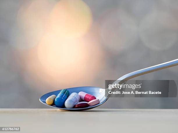 spoon fills of medicines, tablets and pills - tomada de decisão imagens e fotografias de stock