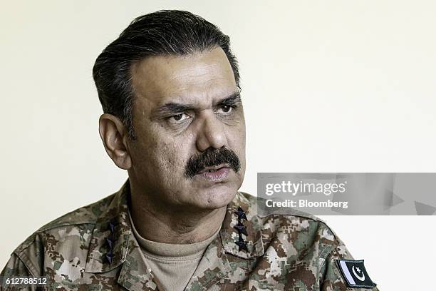 Asim Bajwa, lieutenant general and director-general of the Inter-Services Public Relations , the media wing of the Pakistan Armed Forces, listens...