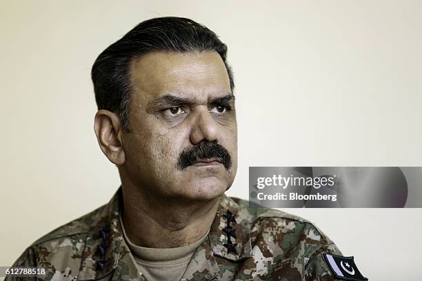 Asim Bajwa, lieutenant general and director-general of the Inter-Services Public Relations , the media wing of the Pakistan Armed Forces, listens...