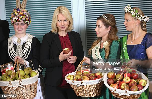 Family Minister Manuela Schwesig receives a basket of apples before the weekly government cabinet meeting on October 5, 2016 in Berlin, Germany....