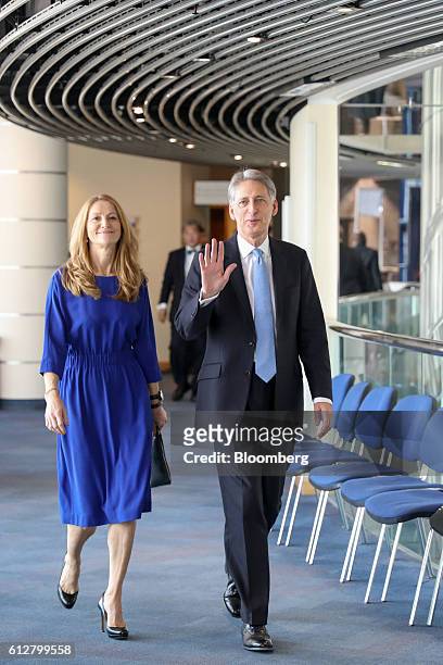 Philip Hammond, U.K. Chancellor of the exchequer, right, and his wife Susan Williams-Walker, arrive to listen to speeches on the closing day at the...