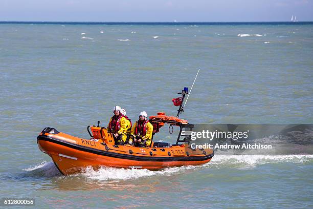 Volunteer crew members in a RNLI Inshore lifeboat - patrol the waters around Folkestone Harbour, Folkestone, Kent. UK. 6th August 2016.