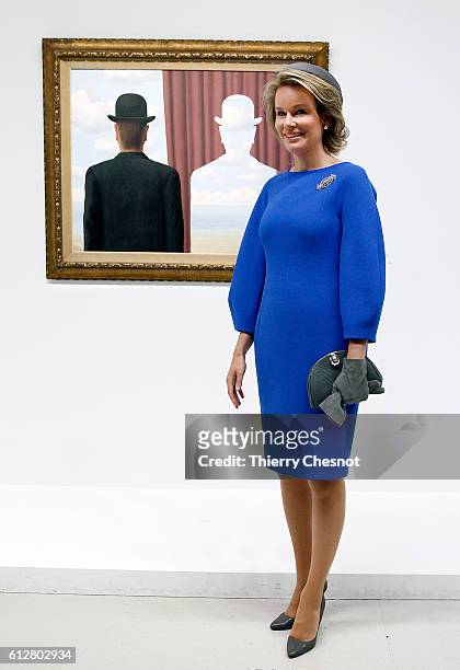 Queen Mathilde of Belgium poses in front of the painting "La decalcomanie, 1966" at the Centre Pompidou modern art museum on October 5, 2016 in...