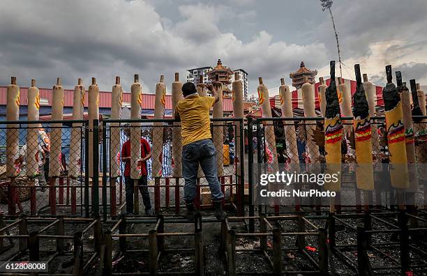 Malaysian ethnic Chinese man installs giant joss sticks to welcome Chinese Nine Emperor Gods in Kuala Lumpur October 5, 2016.