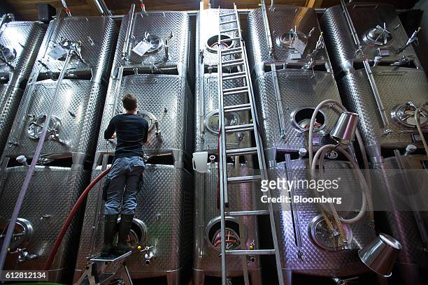 Worker prepares white wine fermentation tanks for use on the Weingut Friedrich Becker Estate vineyard in Schweigen, Germany, on Tuesday, Oct. 4,...