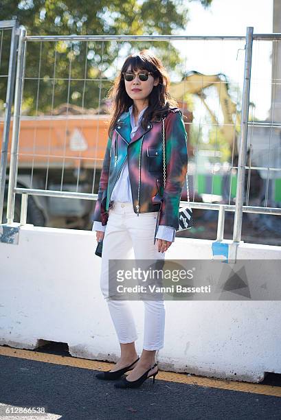 Guest poses wearing Louis Vuitton jacket and bag before the Moncler Gamme Rouge show at the Grand Palais during Paris Fashion Week Womenswear SS17 on...