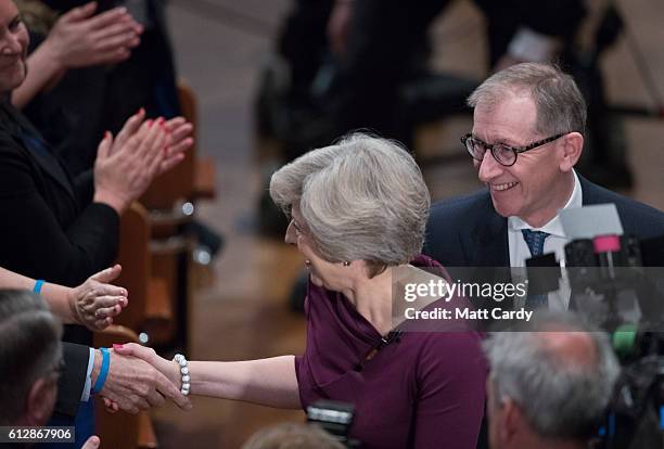 Prime Minister Theresa May and her husband Philip leave the hall after she made her keynote speech as she closes the 2016 Conservative Conference at...