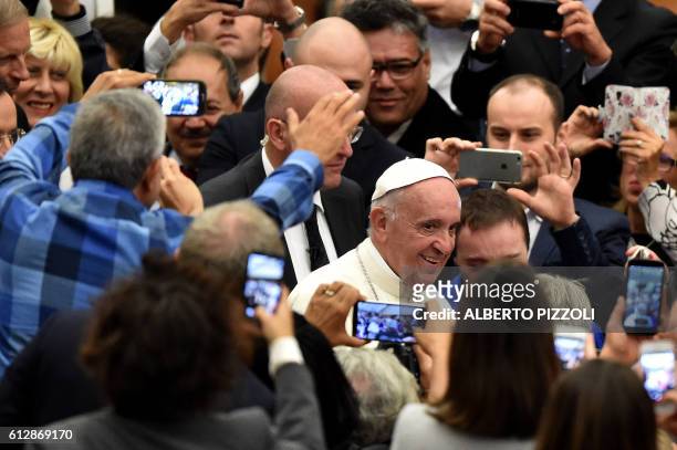 Pope Francis arrives to attend the opening ceremony of a Vatican seminar on sport and society in the Paul VI hall on October 5, 2016 at the Vatican....